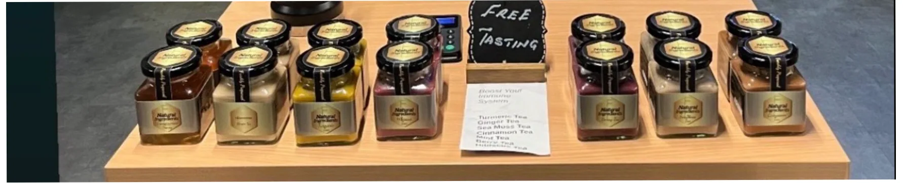 I Natural Ingredients jars arranged on a warm wooden tasting display.